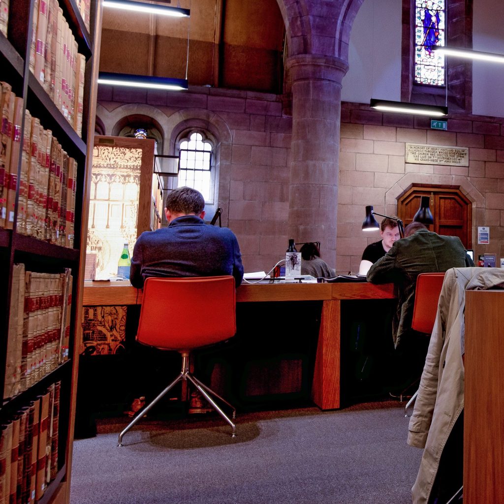 People sitting at desks in a library